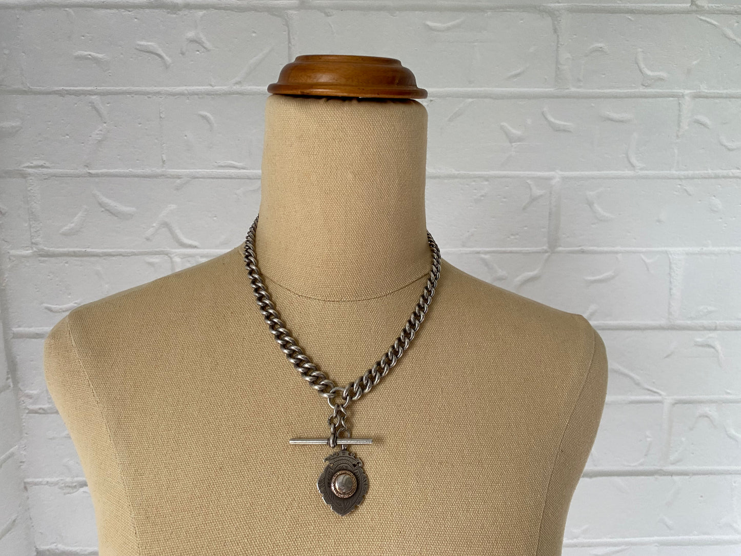 Brass Elizabeth Cole Necklace styled with Hardy Brothers sterling fob chain